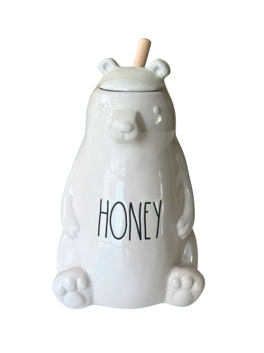 White ceramic honey jar shaped like a bear with 'Honey' text on a white background